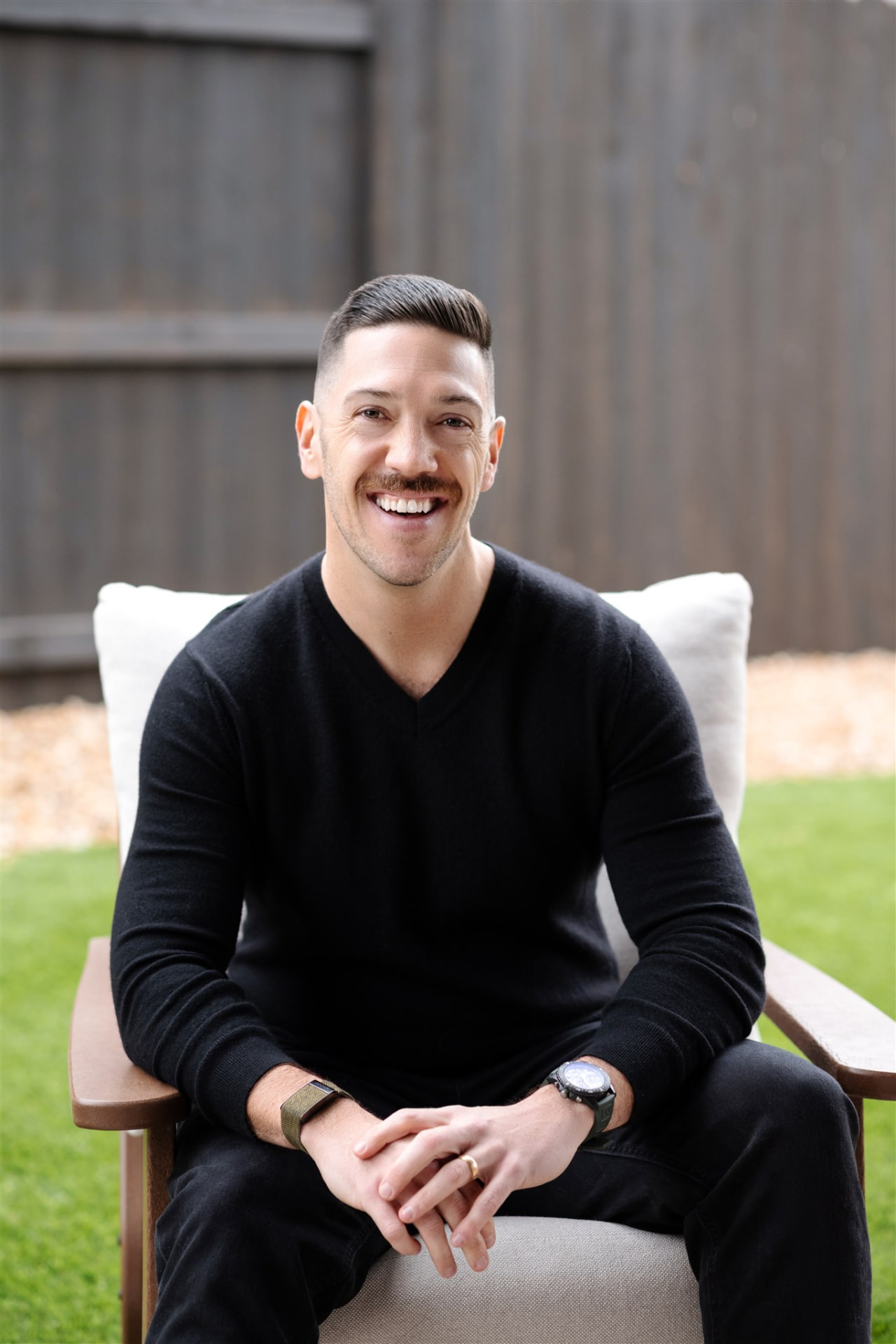 Sean seated outdoors, smiling